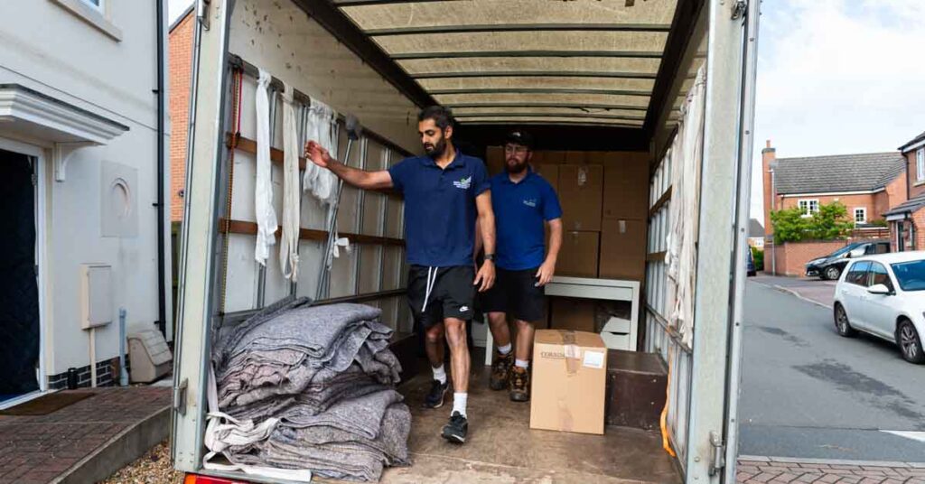 Simply Moving crew stacking furniture and boxes inside a removal van